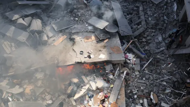 From above, rubble burns following an airstrike