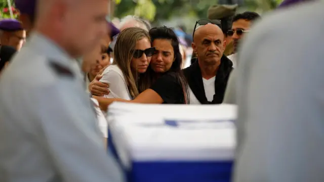 Family and friends mourn at the funeral of Israeli Soldier Col Asaf Hamam, who was killed in the 7 October attacks