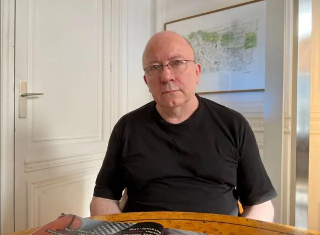 Graham Tearse sitting at a table