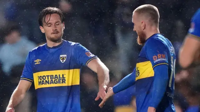 AFC Wimbledon players celebrate their fourth goal against Ramsgate