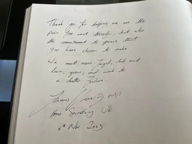 A handwritten note signed by James Cleverly