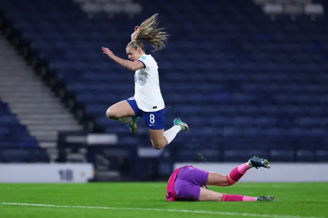 Stanway hrudles the on-rushing Gibson in the Scotland goal.