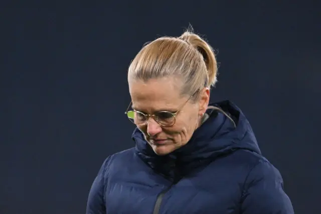 Wiegman bows her head in disappointment as she leaves the pitch.