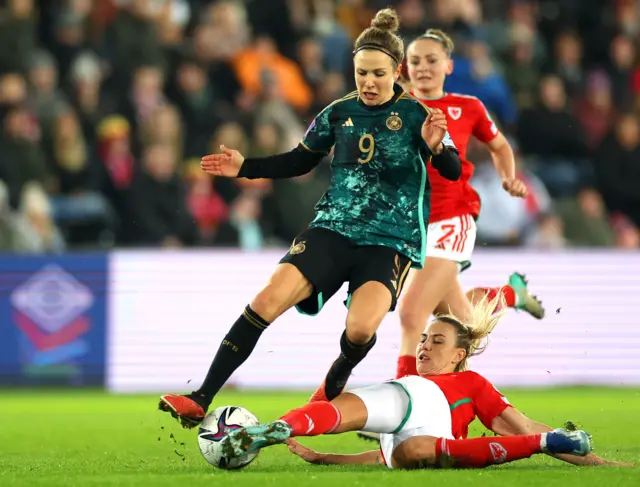 Gemma Evans of Wales makes a sliding tackle