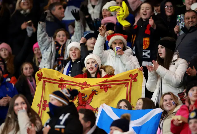 Scotland fans wave flags in the stands.