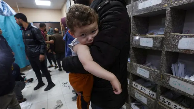 A Palestinian child looks on at Nasser hospital