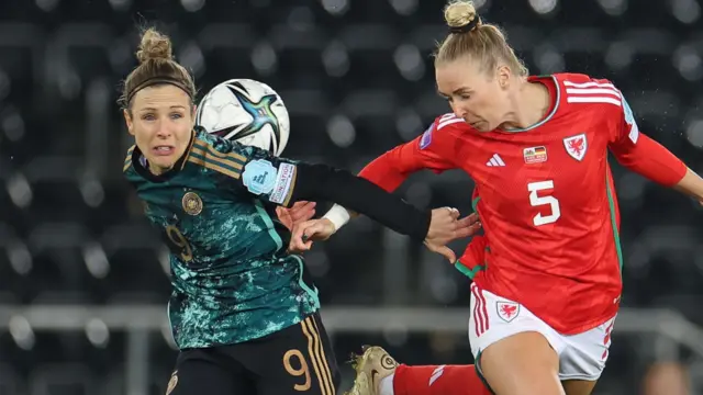 Rhiannon Roberts (right) heads the ball for Wales