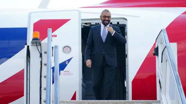 James Cleverly steps out of a plane in Rwanda