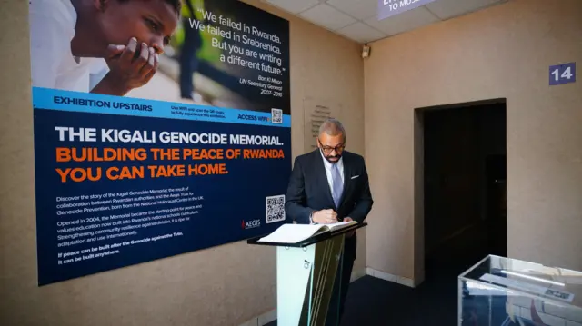 Home Secretary James Cleverly signs a book of condolences at the Kigali Genocide Memorial