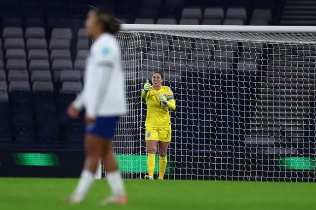 Earps directs her defence from her goal.