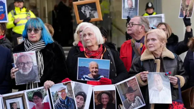 Family members of people who died during the coronavirus disease (COVID-19) pandemic hold pictures during a news conference outside the UK COVID-19 Inquiry