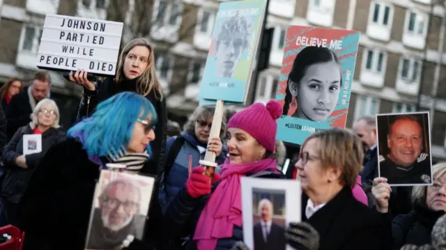 Protesters wait outside the UK Covid-19 Inquiry at Dorland House in LondoN