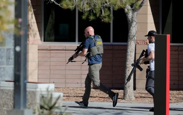 Police officers enter the UNLV campus