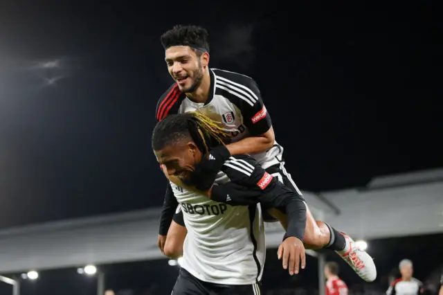 Jimenez and Iwobi celebrate the loatetr's goal for Fulham.