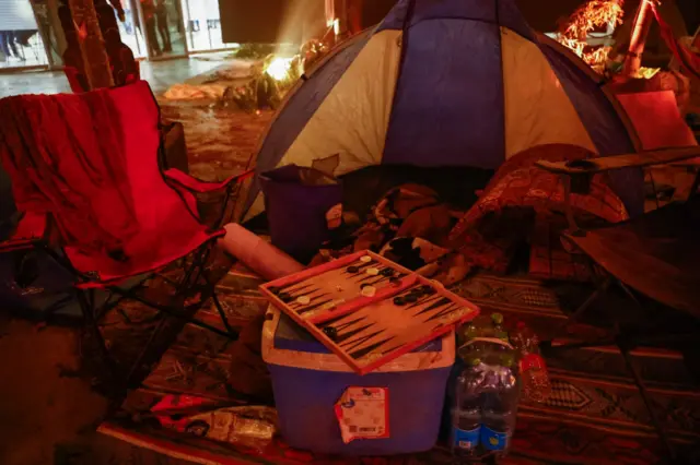 A tent, chairs, a board game and other items from the Supernova music festival are seen in Tel Aviv