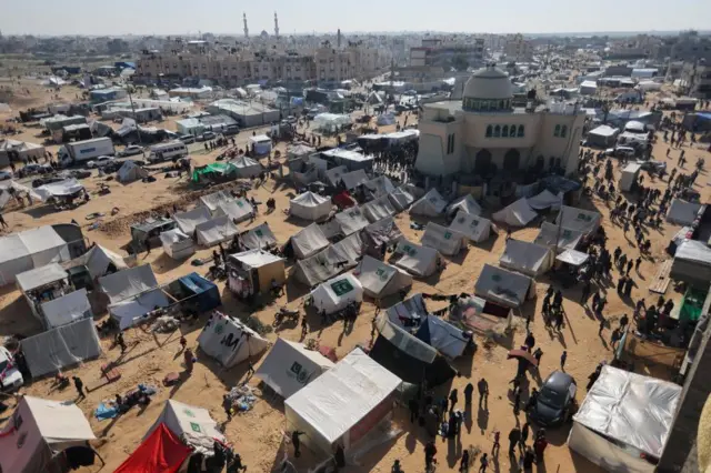 Displaced Palestinians, who fled their houses due to Israeli strikes, shelter in a camp in Rafah