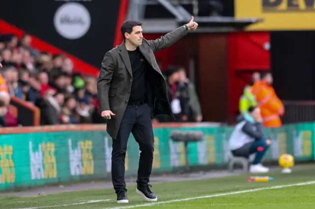 Iraola gestures to his players from the touchline.