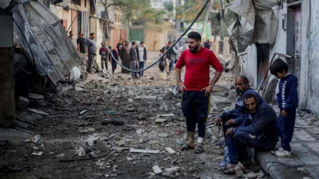 Palestinians react at the site of Israeli strikes, amid the ongoing conflict between Israel and the Palestinian Islamist group Hamas, in Khan Younis in the southern Gaza Strip