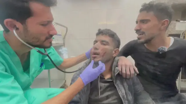 A doctor works on a patient at Nasser Hospital in Khan Younis