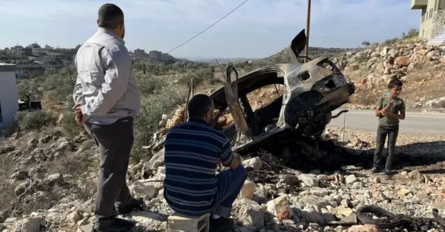 A burnt-out car in Khirbet Zanuta