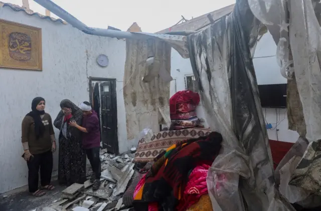 Palestinians check damage at site of Israeli air strike in Khan Younis