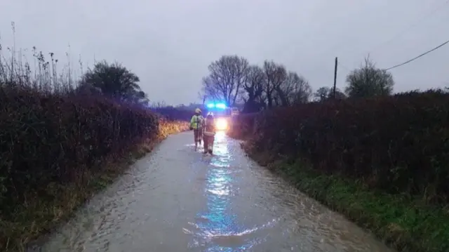 Fire crews in flood water