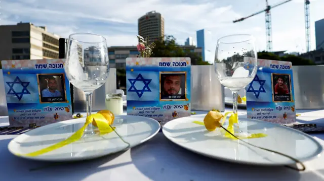 Close-up of plates on empty dinner table to mark hostages