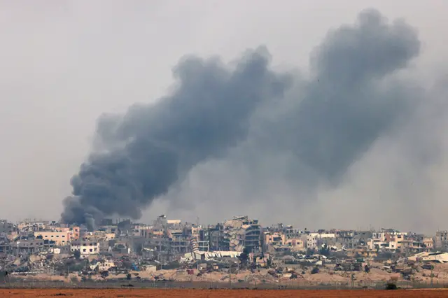 A view of Gaza shows smoke rising during Israeli shelling, taken from southern Israel on 7 December