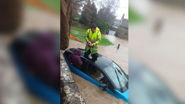 Woman being rescued from car