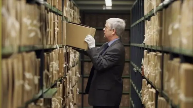 Guy holding box of files