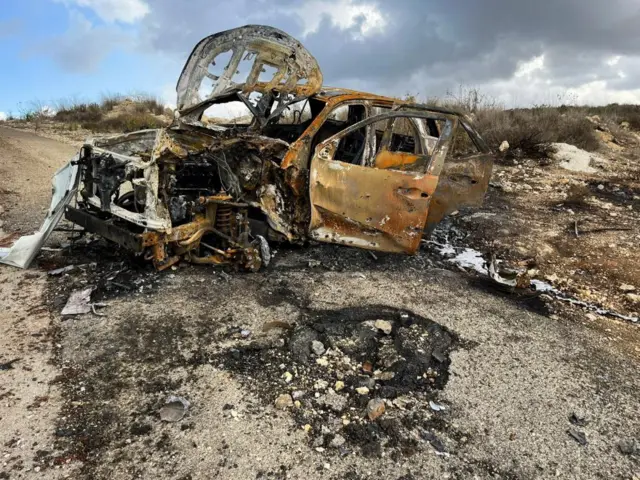 Burnt out car at site of strikes at Israel-Lebanon border on 13 October