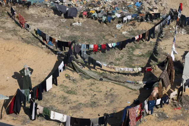 This aerial view shows laundry hanging to dry in a camp set up by Palestinians in Rafah, 7 December 2023