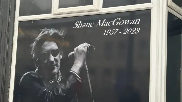 A window in nenagh with a tribute to Shane MacGowan