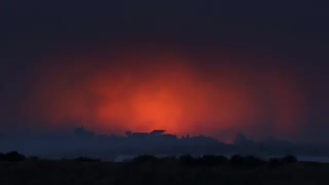 Fire burns and smoke rises following an explosion during Israeli air strikes over Gaza