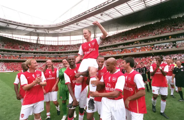 Dennis Bergkamp is lifted on his former Arsenal team-mates shoulders during his testimonial at Emirates Stadium