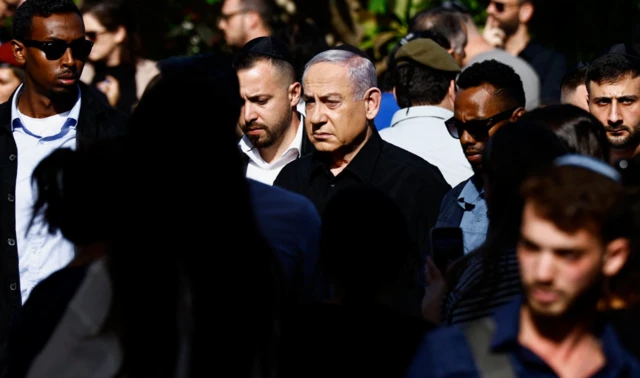 Israeli Prime Minister Benjamin Netanyahu attends the funeral of Gal Meir Eisenkot, 25, an Israeli solider and the son of Israeli cabinet minister and former military chief Gadi Eizenkot