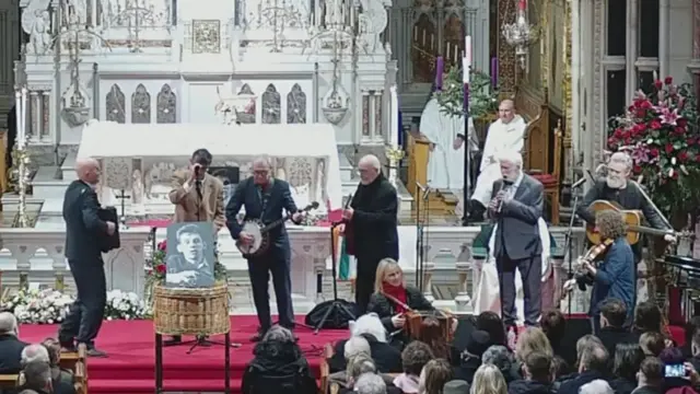 Former members of the Pogues playing at the funeral