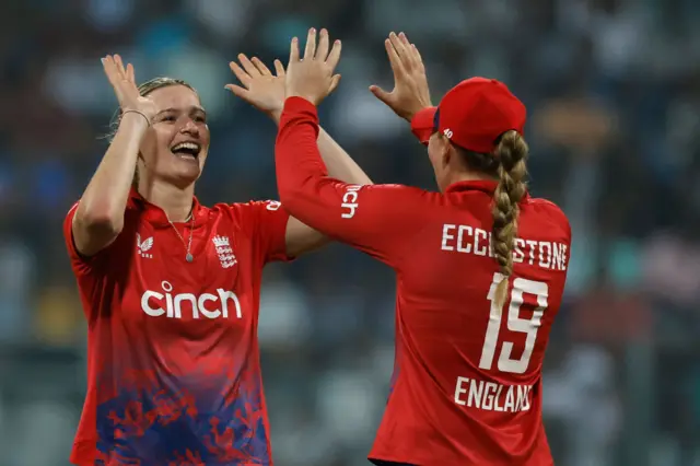 England women celebrate a wicket against India