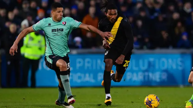 Jevani Brown of Bristol Rovers battles for the ball with Brandon Liggett of Cheltenham Town