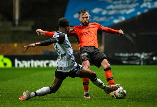 Ayr's Ben Dempsey challenges Dundee United's Scott McMann