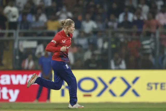 Charlie Dean celebrates taking a wicket