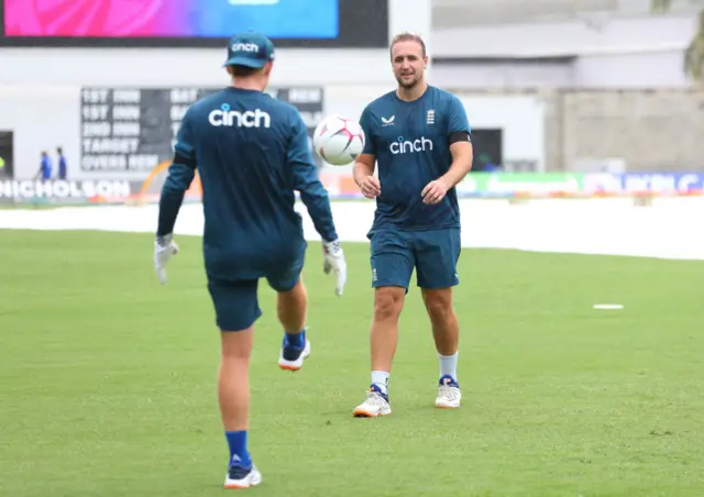 Liam Livingstone (R) and Ollie Pope (L) of England play football as rain delays the start of play during the third CG United One Day International match between West Indies and England at Kensington Oval on December 09, 2023 in Bridgetown, Barbados.