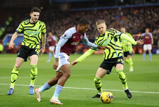 Oleksandr Zinchenko is challenged by Leon Bailey