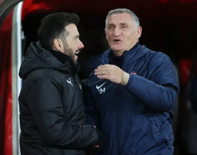 Carlos Corberan and Tony Mowbray exchange a chuckle