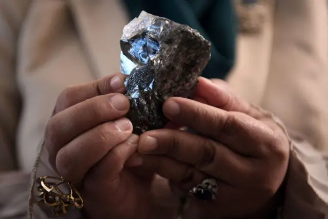 A member of the Botswana cabinet holds a 1,174-carat diamond in Gaborone, Botswana, on July 7, 2021