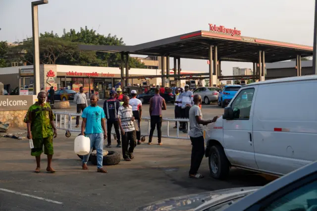 People gather at petrol stations to buy fuel