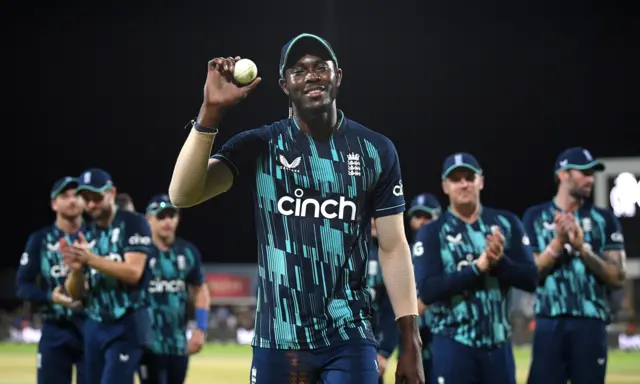 Jofra Archer walks off with the match ball