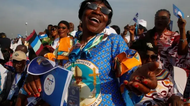 A woman celebrates the Pope