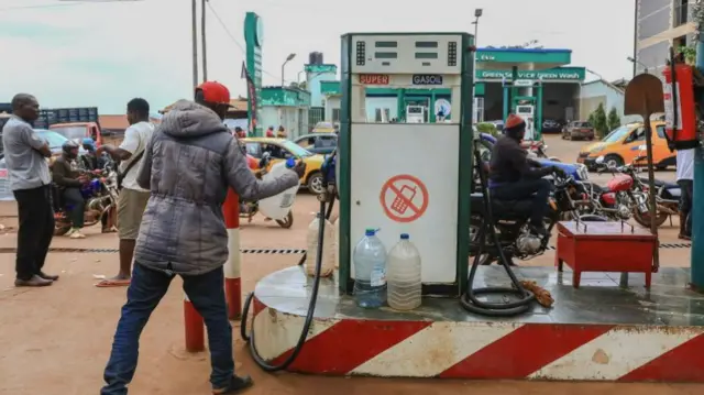 People queue for fuel at a fuel station in Yaounde