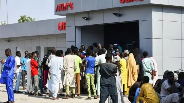 People queuing at an ATM.